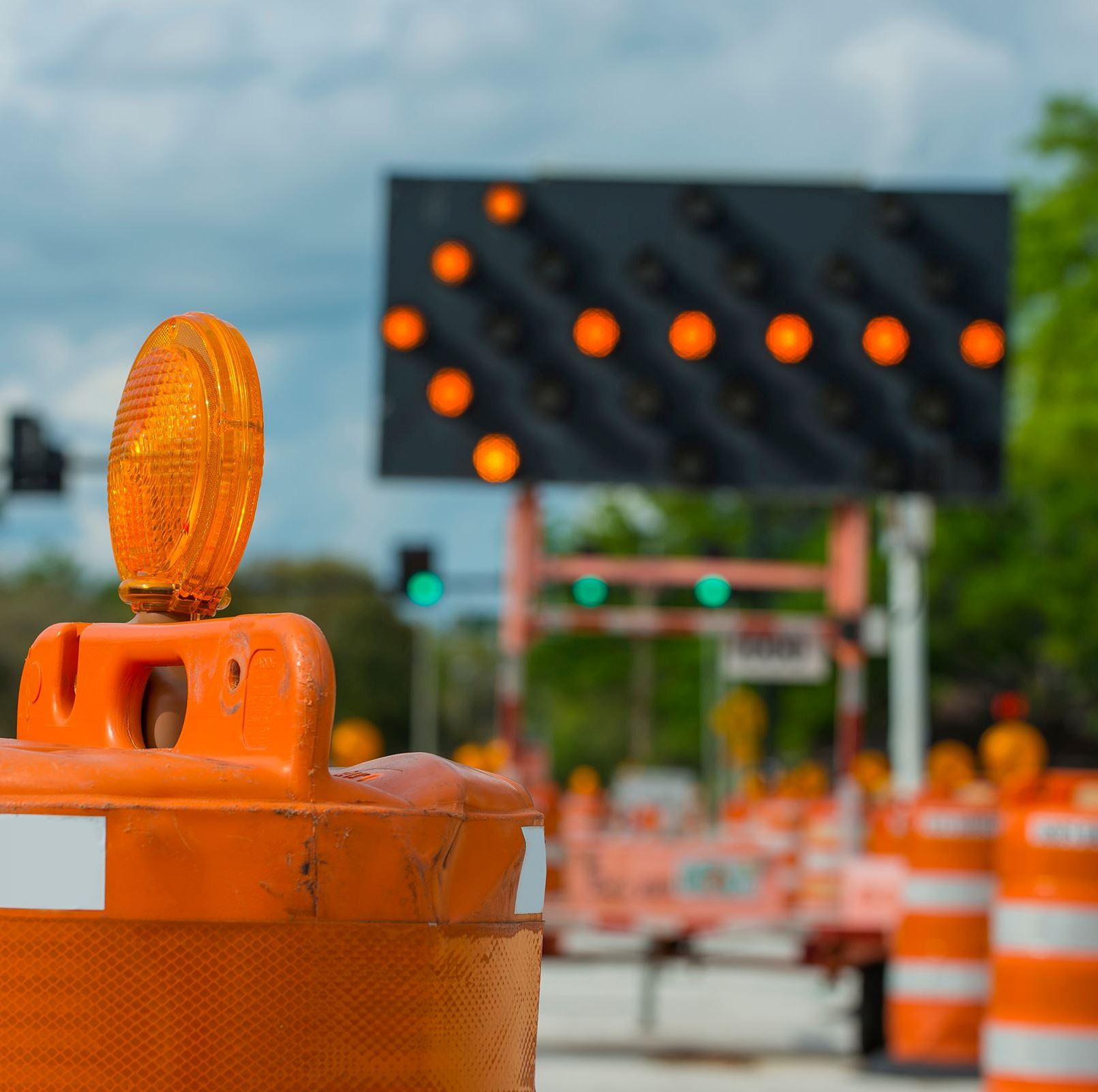 A lighted arrow sign directing drivers into another lane.