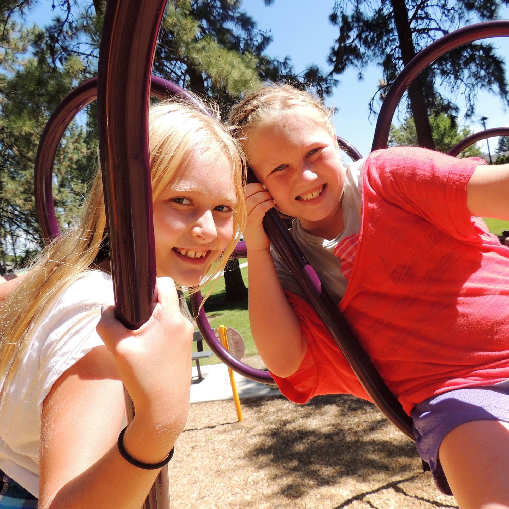 Two female campers playing on playground eqipment